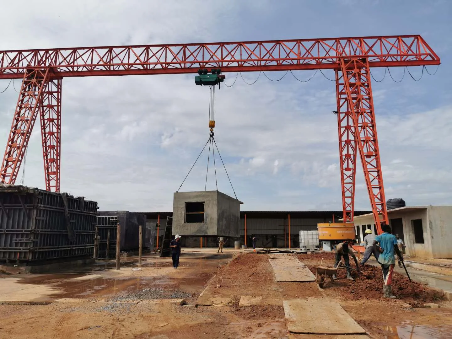 Precast concrete production yard with a gantry crane and manufactured modules