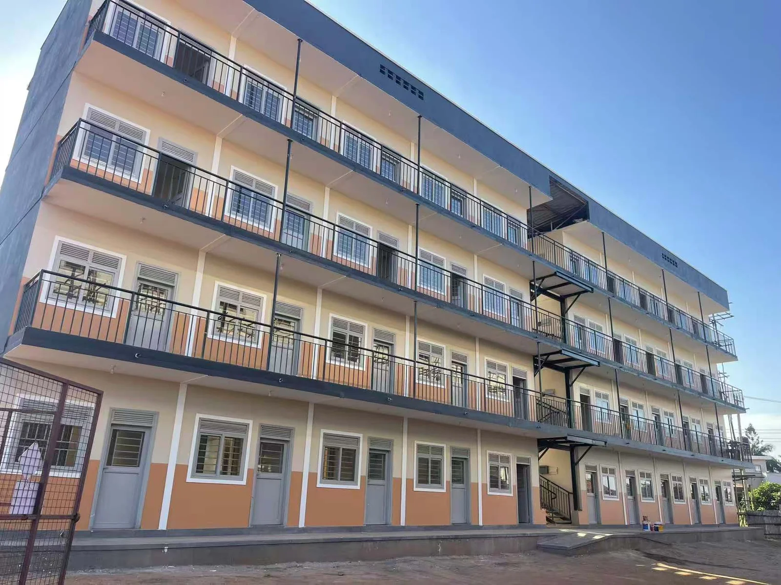 Completed multi-storey modular residential building with balconies and exterior stairs